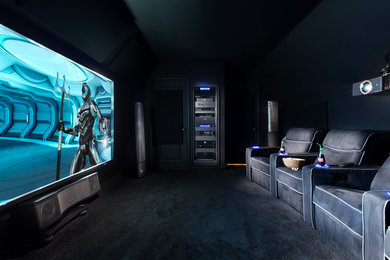 Home theater - mid-sized contemporary enclosed carpeted and black floor home theater idea in Birmingham with black walls and a projector screen