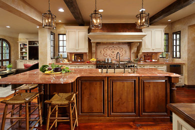 Kitchen - mediterranean medium tone wood floor kitchen idea in Minneapolis with beaded inset cabinets, marble countertops and mosaic tile backsplash