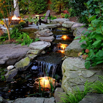 Alexandria Sloped Yard - Raised Patio, Fire Pit, & Water Feature