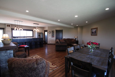Example of a medium tone wood floor and blue floor family room design in Other with beige walls