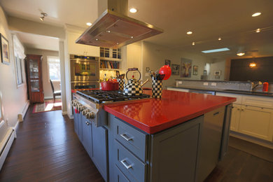 Inspiration for a mid-sized transitional u-shaped dark wood floor open concept kitchen remodel in Denver with an undermount sink, recessed-panel cabinets, granite countertops, gray backsplash, glass tile backsplash, stainless steel appliances, an island and gray cabinets