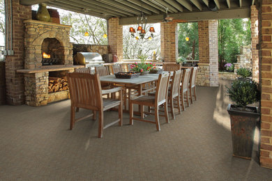 Design ideas for a large traditional backyard patio in Tampa with a fire feature and a roof extension.