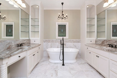 This is an example of a mid-sized transitional master bathroom in Dallas with shaker cabinets, white cabinets, a freestanding tub, gray tile, white tile, marble, grey walls, marble floors, an undermount sink, granite benchtops, grey floor and grey benchtops.