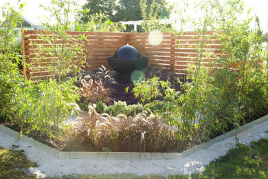 This is an example of a small contemporary full sun garden in Perth with a water feature.