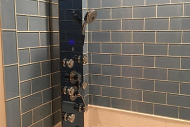 Example of a trendy blue tile, white tile and subway tile alcove shower design in New York