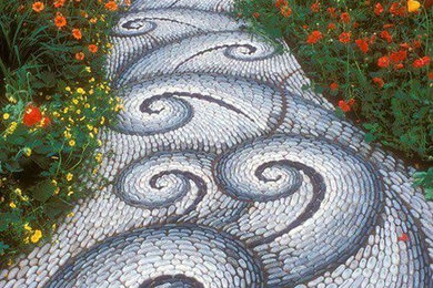 This is an example of a mid-sized eclectic partial sun side yard stone landscaping in Miami for spring.