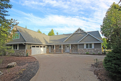 Inspiration for a large contemporary beige house exterior in Other with mixed siding, a gable roof, a shingle roof, a grey roof and board and batten siding.