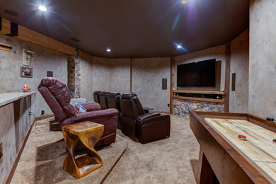 Inspiration for a large rustic open concept dark wood floor and brown floor game room remodel in DC Metro with gray walls, a standard fireplace, a stone fireplace and a wall-mounted tv