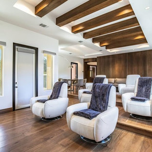 Trendy enclosed dark wood floor and brown floor home theater photo in Austin with white walls