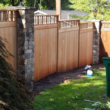 Cedar fence with stone columns and electric lanterns - before and after pictures