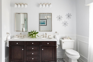 Design ideas for a large traditional master bathroom in New York with shaker cabinets, dark wood cabinets, white tile, ceramic tile, marble floors, an undermount sink, engineered quartz benchtops, grey floor, white benchtops, a two-piece toilet, grey walls, a claw-foot tub, an alcove shower, a hinged shower door, a double vanity, a freestanding vanity and decorative wall panelling.