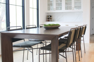 Light wood floor dining room photo in Cincinnati with white walls