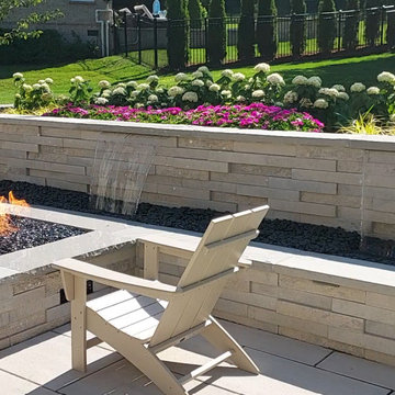 Contemporary Waterfall Wall Connected to the Gas Fire Pit