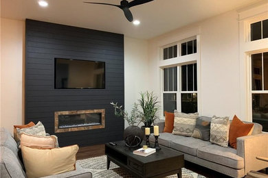 Mid-sized country formal and open concept dark wood floor and brown floor living room photo in Indianapolis with white walls, a ribbon fireplace, a wood fireplace surround and a wall-mounted tv