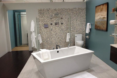 Inspiration for a large contemporary master gray tile and stone tile bamboo floor bathroom remodel in Orange County with flat-panel cabinets, dark wood cabinets, a two-piece toilet, blue walls, an undermount sink and solid surface countertops