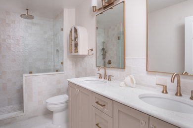 Transitional kids' pink tile and ceramic tile marble floor and double-sink bathroom photo in Raleigh with shaker cabinets, beige cabinets, a two-piece toilet, an undermount sink, quartz countertops, a hinged shower door, white countertops, a niche and a built-in vanity