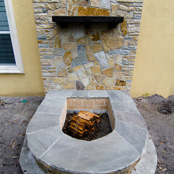 Sandstone & Brick Fire Pit with Quartzite Wall with Arch & Cross