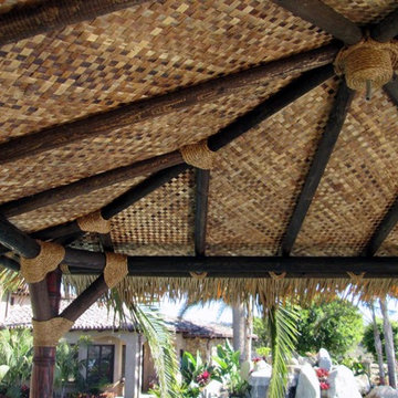 12'x12' Maldives inspired Hut in Synthetic thatch - carved poles in teak stain