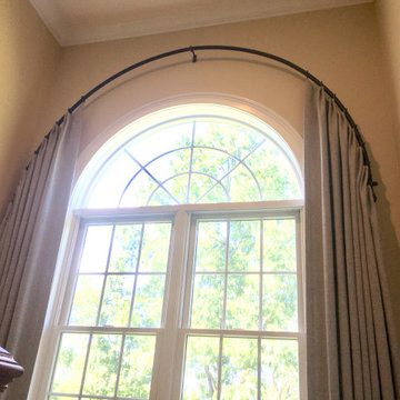 Arched foyer draperies on custom bent rod