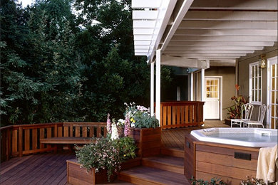 Inspiration for a mid-sized transitional backyard deck container garden remodel in San Francisco with a pergola