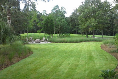 This is an example of a traditional partial sun backyard mulch landscaping in Charleston.