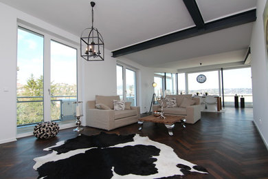 Design ideas for a contemporary formal living room in Stuttgart with white walls and dark hardwood floors.