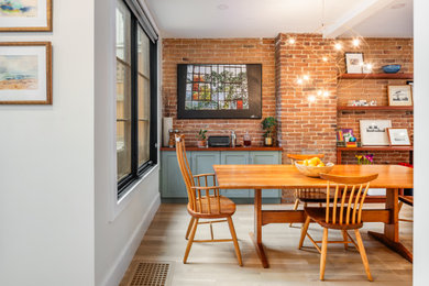 Inspiration for a mid-sized transitional light wood floor kitchen/dining room combo remodel in Boston with beige walls