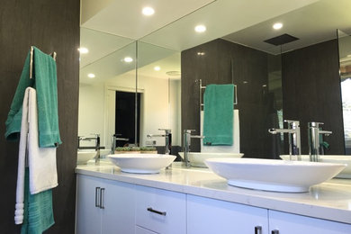 Inspiration for a mid-sized modern 3/4 bathroom in Melbourne with white cabinets, a corner shower, a wall-mount toilet, gray tile, porcelain tile, white walls, ceramic floors, a vessel sink, marble benchtops, grey floor, an open shower and yellow benchtops.