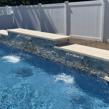Unilock XL smooth Almond Grove Pool Patio with Travertine Waterfalls - Deer Park