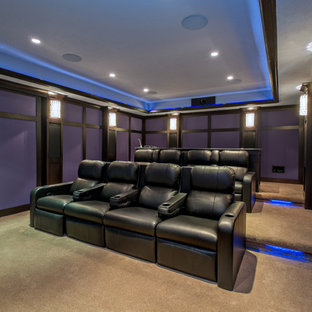 Photo of a large classic enclosed home cinema in Grand Rapids with blue walls, carpet and a projector screen.