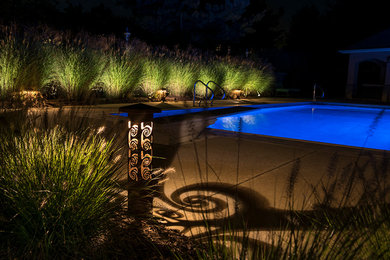 Example of a mid-sized backyard concrete and rectangular pool design in Other