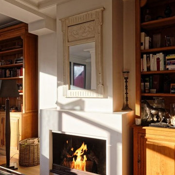 Cheminée classique en staff foyer ouvert habillé de plaques d'acier