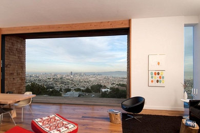 Example of a mid-sized trendy open concept medium tone wood floor family room design in San Francisco with white walls