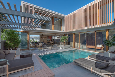 This is an example of an expansive beach style backyard rectangular lap pool in Sunshine Coast with decking.