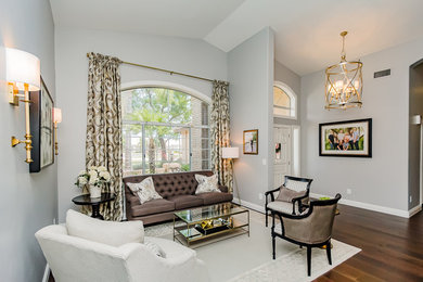 Inspiration for a mid-sized timeless formal and open concept medium tone wood floor and brown floor living room remodel in Phoenix with gray walls, no fireplace and no tv