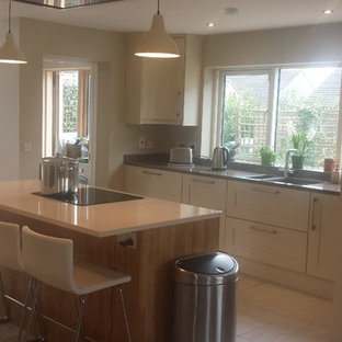 Mid-sized contemporary kitchen pantry designs - Kitchen pantry - mid-sized contemporary l-shaped ceramic floor kitchen pantry idea in Dublin with an undermount sink, shaker cabinets, light wood cabinets, quartzite countertops, stainless steel appliances and an island