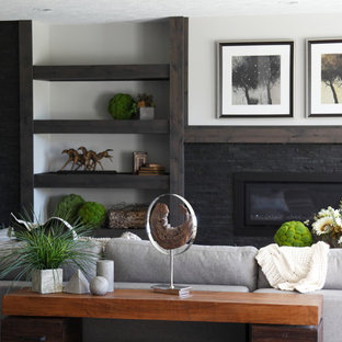 Photo of a large classic walk-out basement in Other with grey walls, carpet, a stone fireplace surround and a ribbon fireplace.