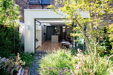 Inspiration for a large contemporary back full sun garden for spring in London with a garden path, gravel and a wood fence.