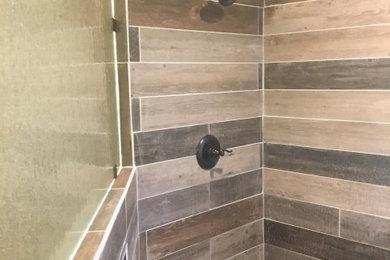 Inspiration for a timeless brown tile, multicolored tile and porcelain tile corner shower remodel in Austin