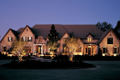 This is an example of a large traditional front yard garden in Dallas.