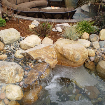 Waterfeatures, lowered seating area next to a running creek bed with planted pot