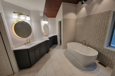Double-sink freestanding bathtub photo in Detroit with white countertops