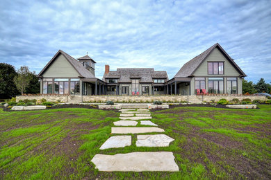 Inspiration for a large transitional green two-story wood exterior home remodel in Toronto with a shingle roof