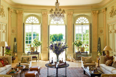 Example of a large classic formal and enclosed terra-cotta tile living room design in Los Angeles with green walls, no fireplace and no tv