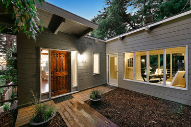 Mid-sized trendy gray three-story mixed siding flat roof photo in Other