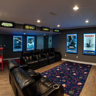 This is an example of a medium sized modern open plan home cinema in Vancouver with grey walls, lino flooring and a built-in media unit.