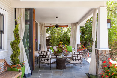 Inspiration for a large craftsman backyard patio remodel in Austin with a roof extension