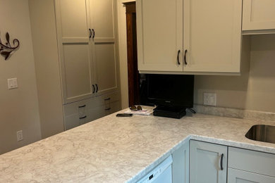 Mid-sized minimalist l-shaped kitchen pantry photo in Other with laminate countertops