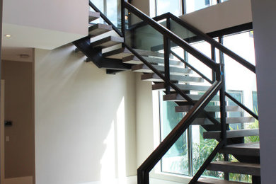 Design ideas for a mid-sized transitional wood staircase in Other with open risers and mixed railing.