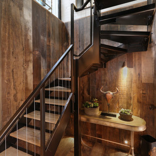 Photo of a rustic wood curved staircase in London with open risers.